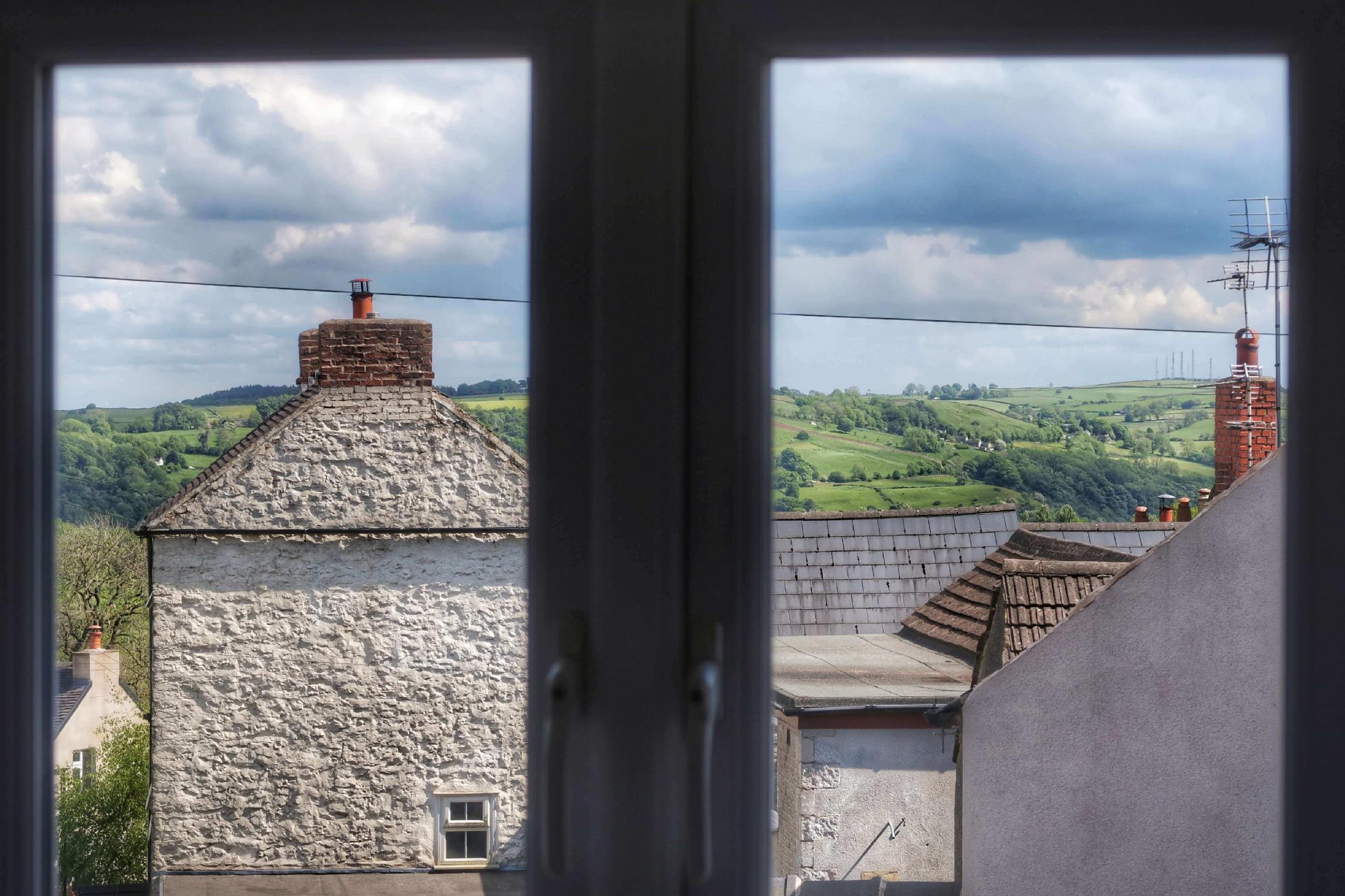Look out from the bedroom at Eight The Green to Bolehill and Alport Height